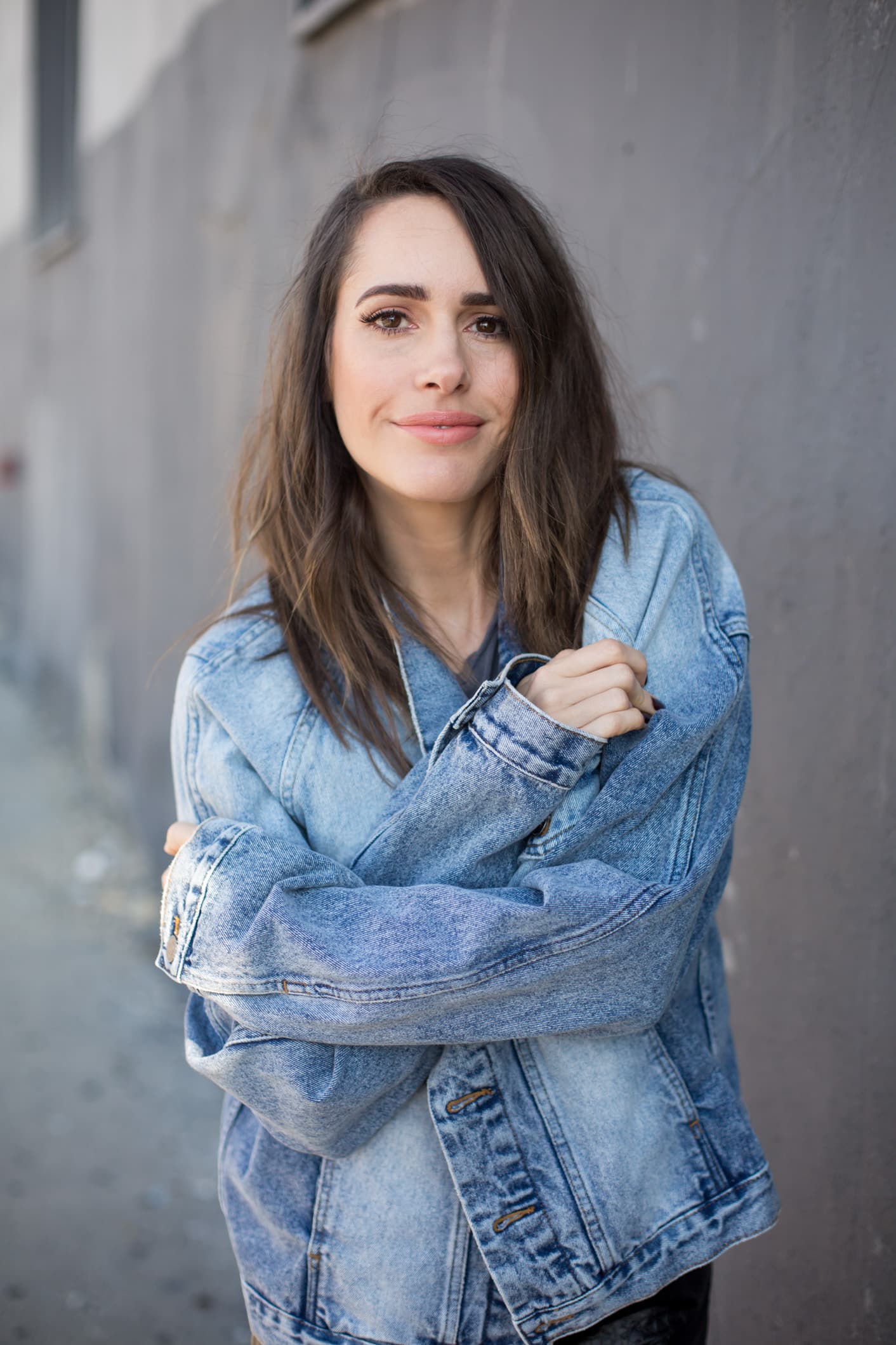 Louise Roe wearing a denim jacket and leather skirt