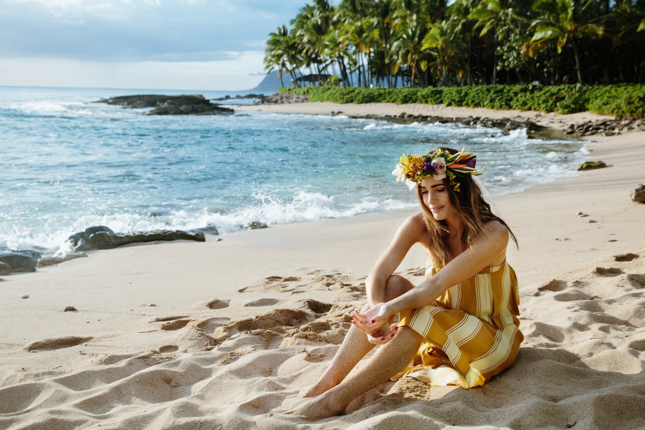 Louise Roe wearing a flower crown and faithfull the brand set on the beach in Hawaii