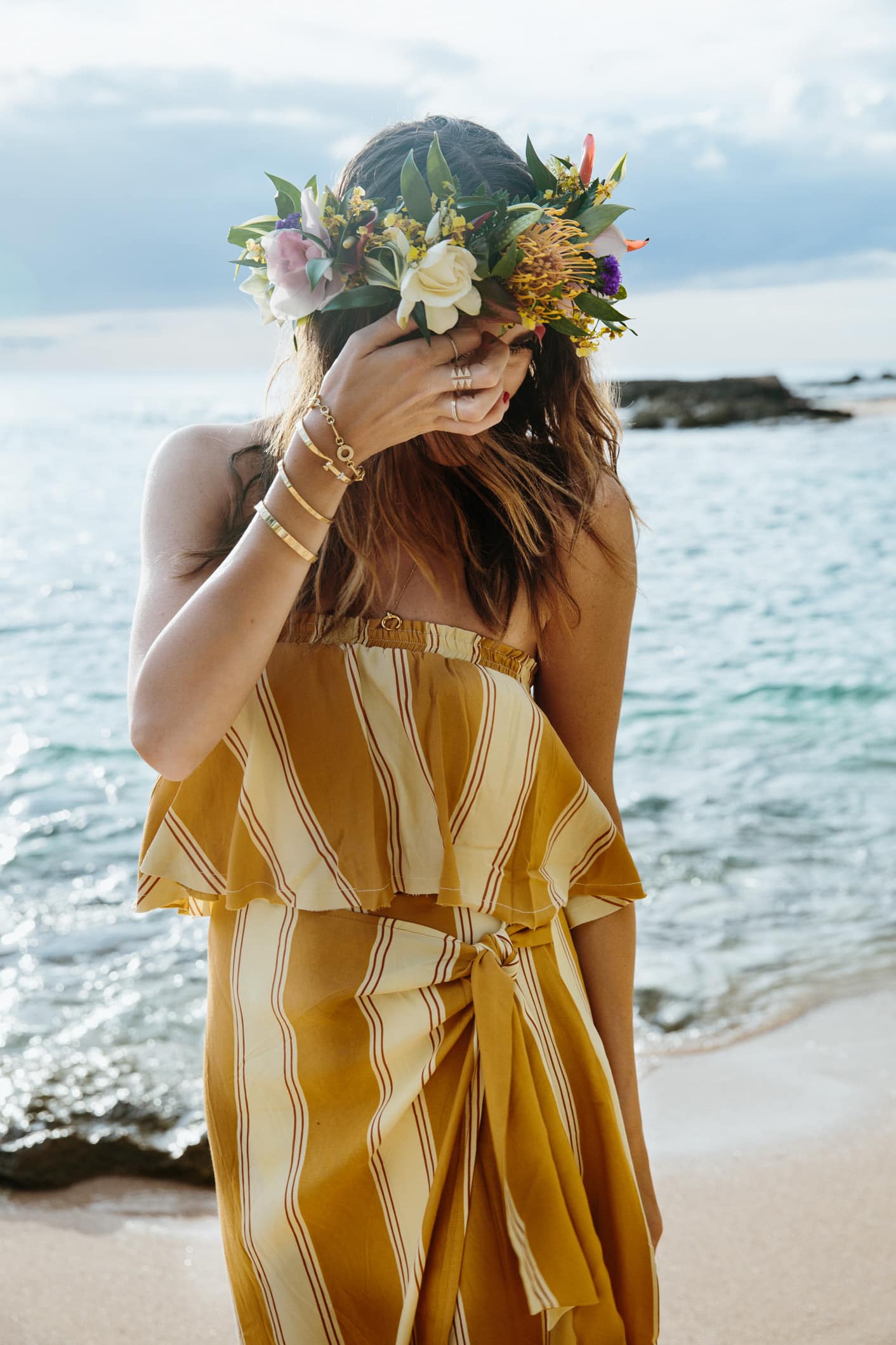 Louise Roe wearing a flower crown and faithfull the brand set on the beach in Hawaii