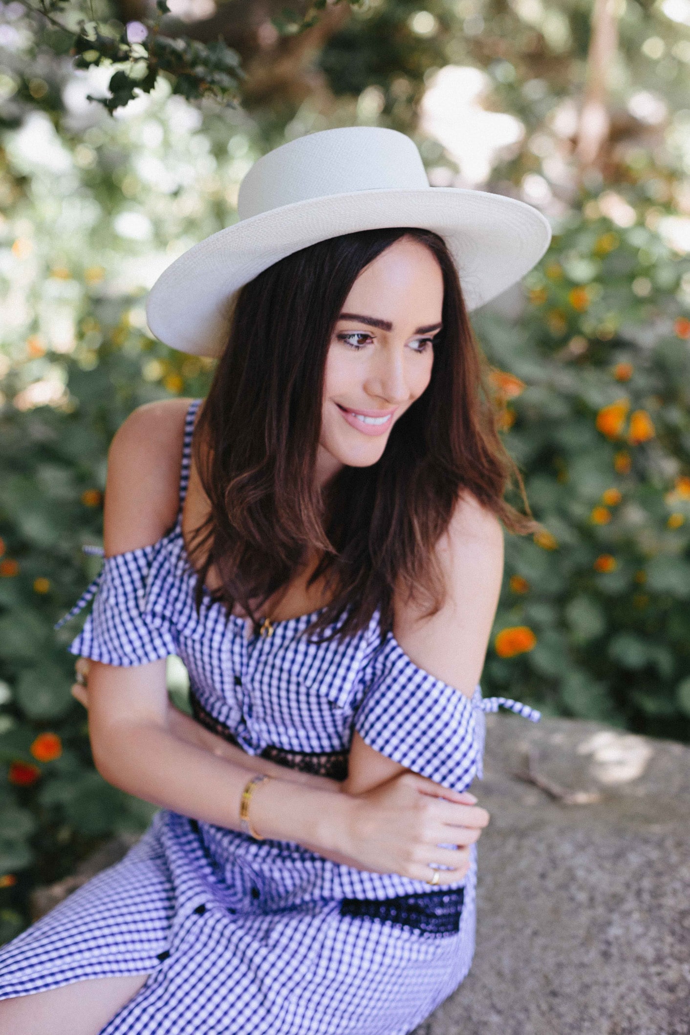 Louise Roe wearing a gingham dress and hat in Santa Barbara