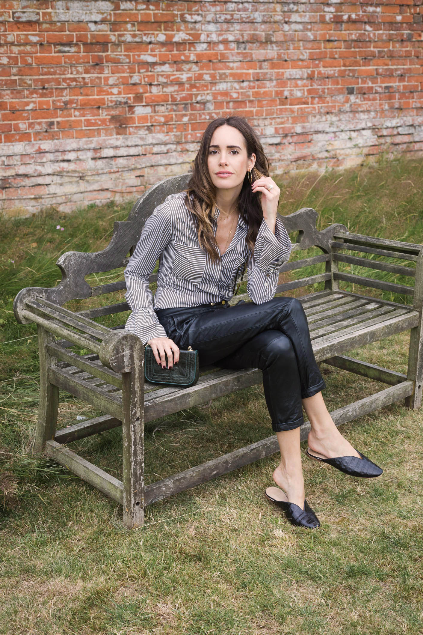 Louise Roe showcases a chic work outfit featuring leather pants and a striped blouse