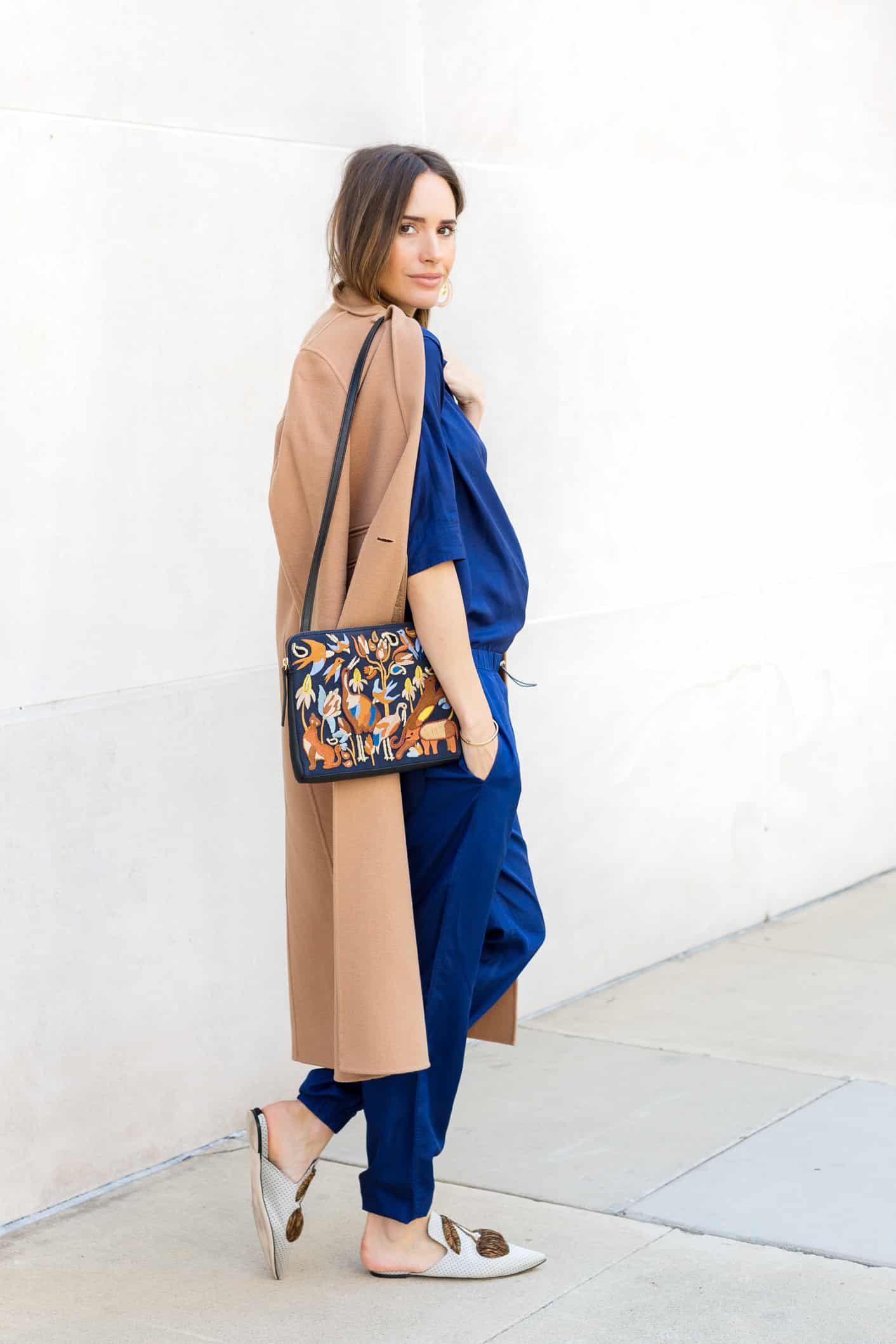 Louise Roe wearing a camel coat and blue pantsuit for fall
