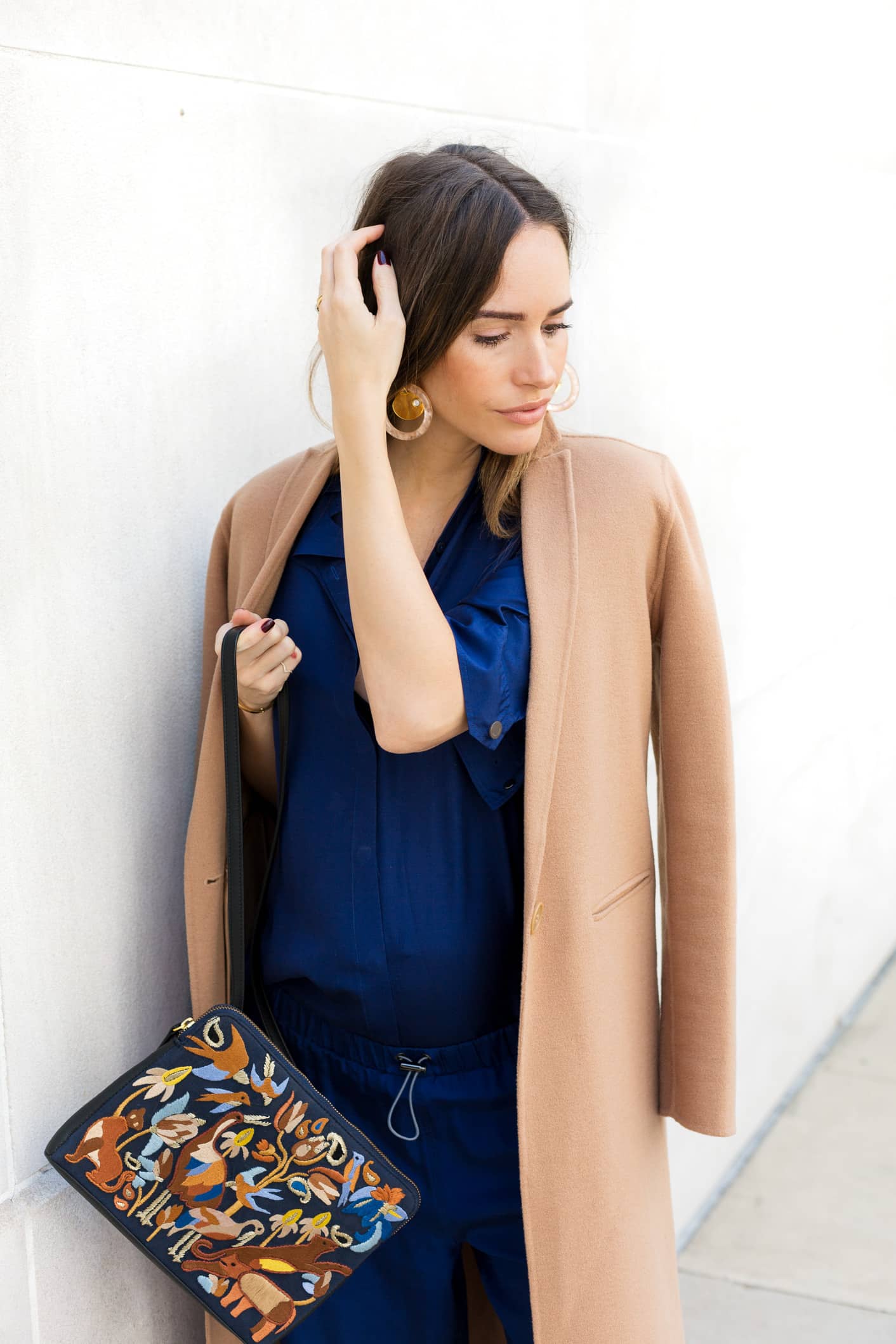 Louise Roe wearing a camel coat and blue pantsuit for fall