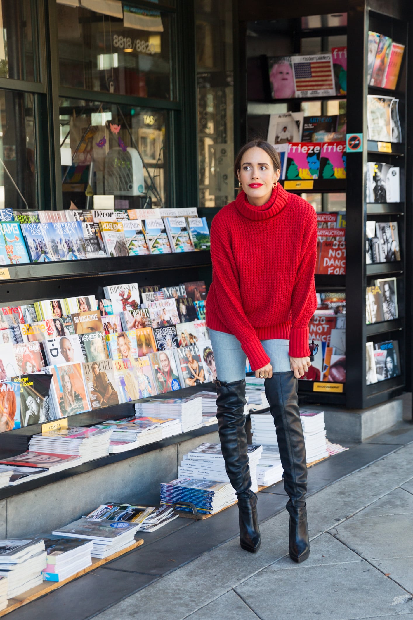 Louise Roe wearing bold red sweater with over the knee boots jeans and red lipstick