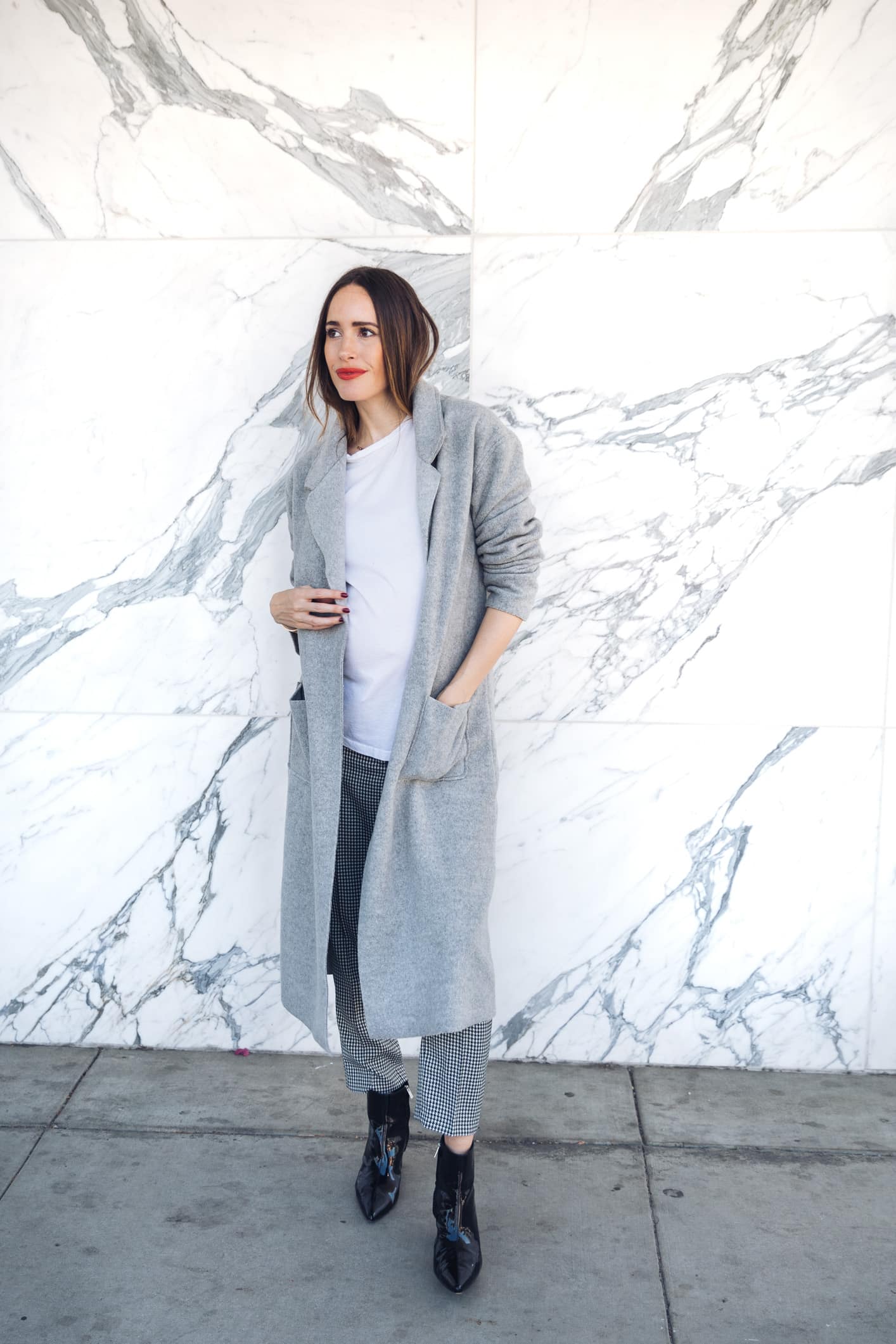 Louise Roe wearing cozy Fall coat in grey and gingham trousers
