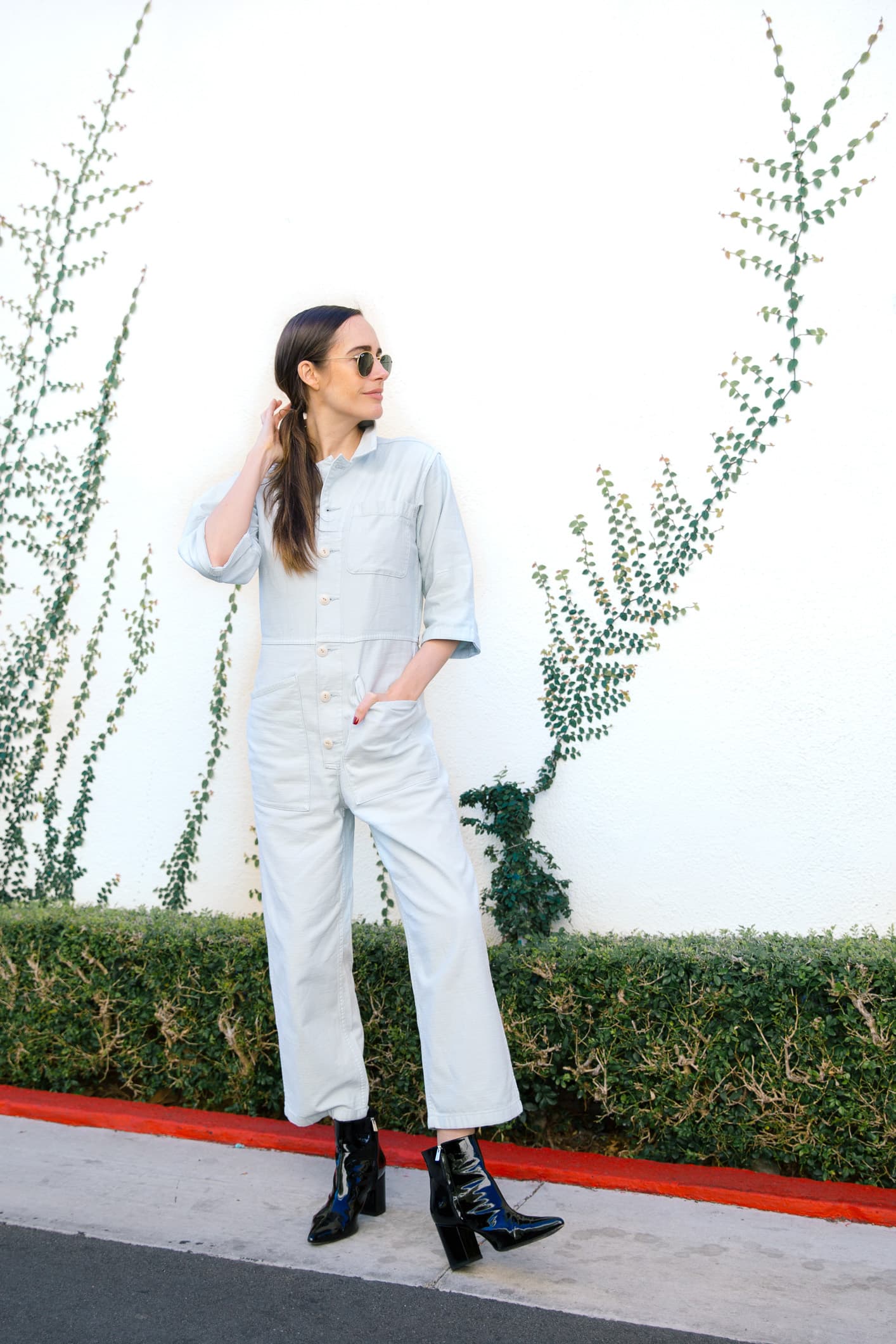 Louise Roe wearing denim spring jumpsuit and Anine Bing cardigan and boots