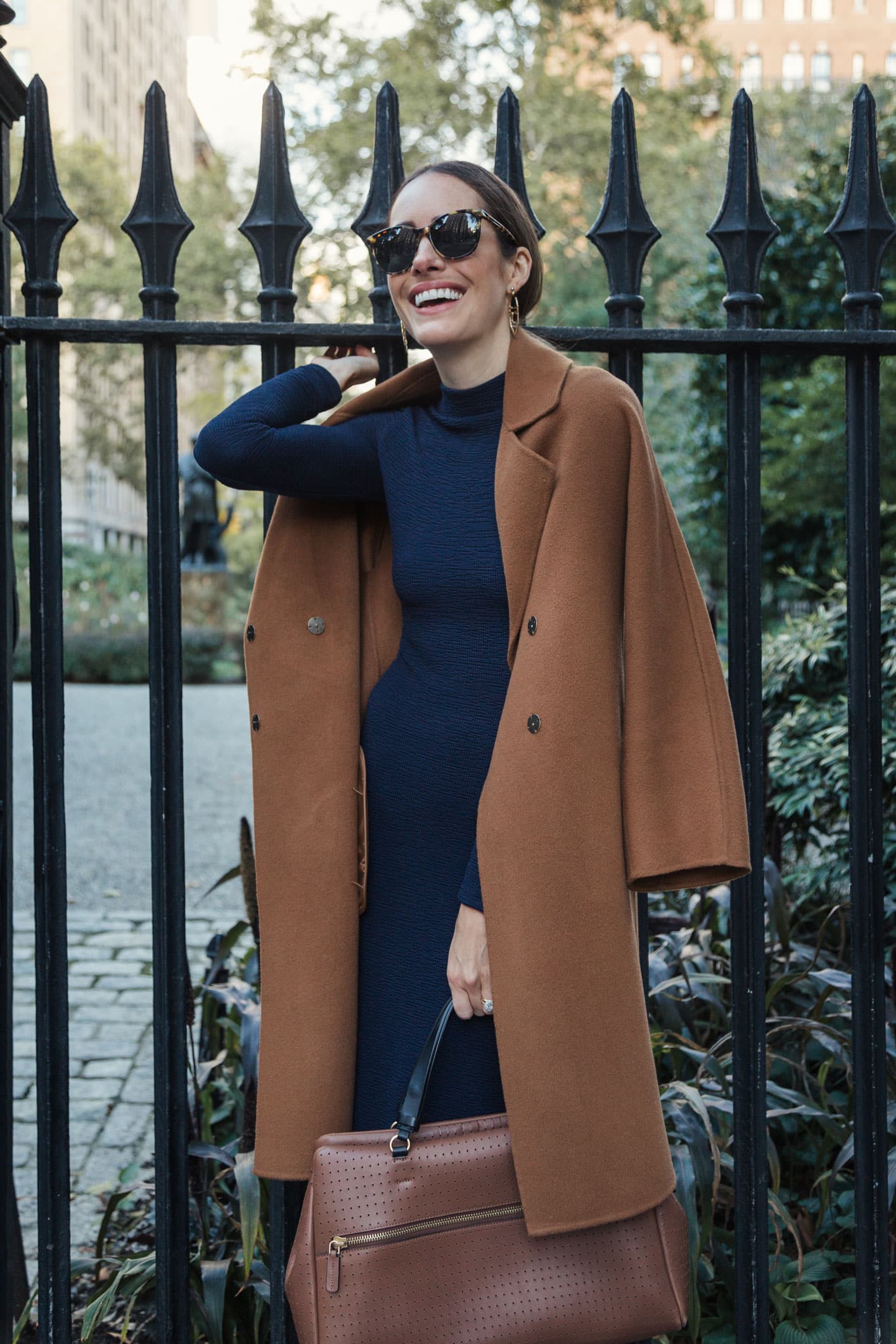 Louise Roe wearing fall outfit with navy dress and camel coat