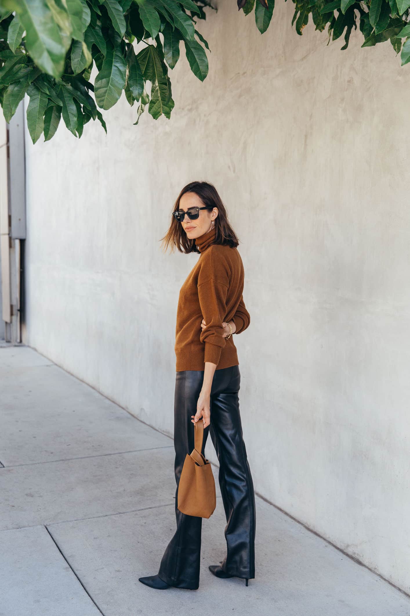Louise Roe wearing theory leather trousers and camel sweater fall outfit