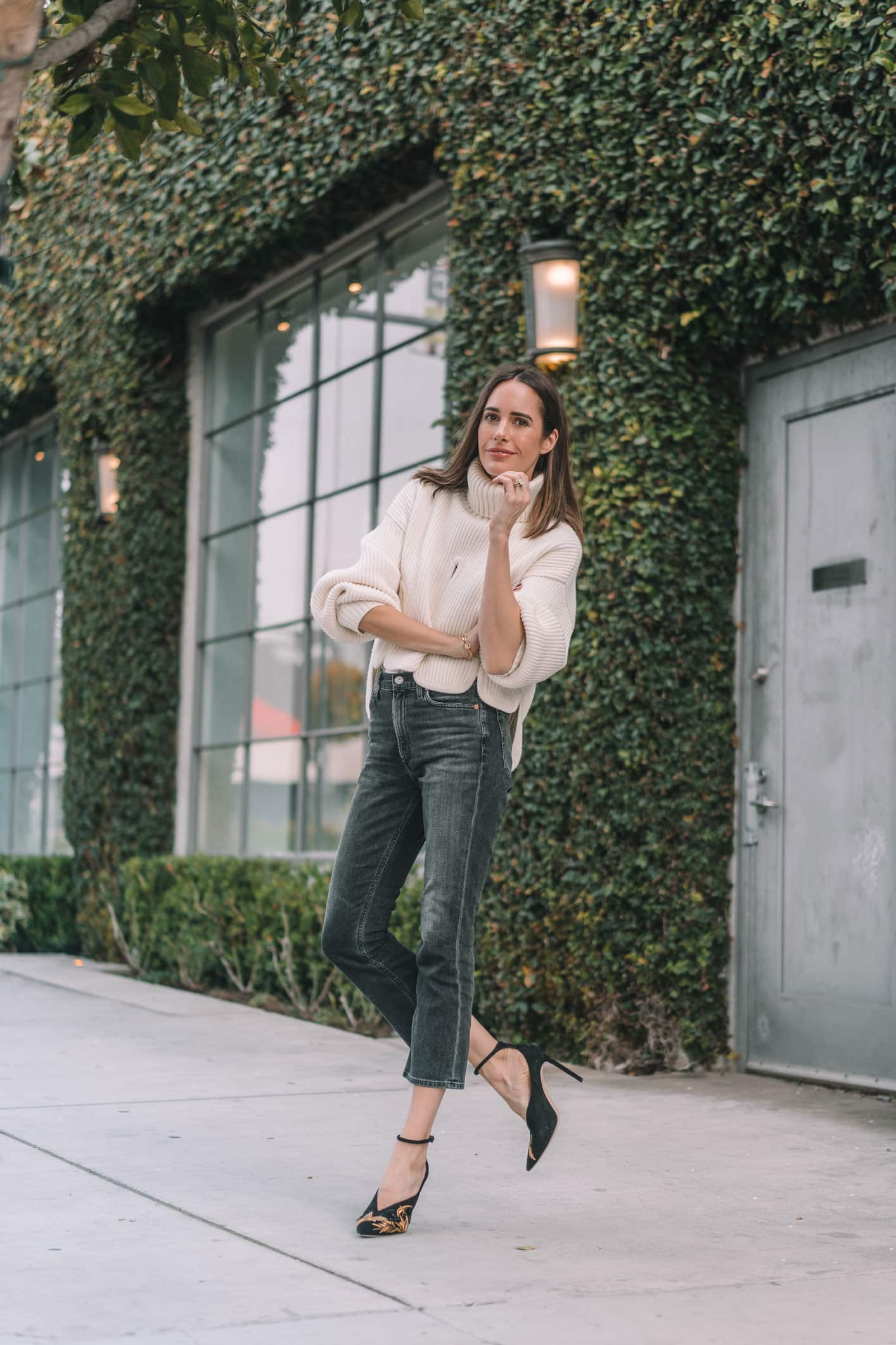 Louise Roe wearing Frame jeans ivory sweater and Jimmy Choo statement heels